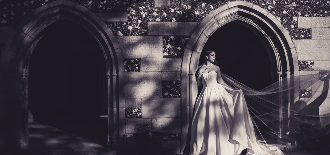 Bride Standing Under Stone Archway