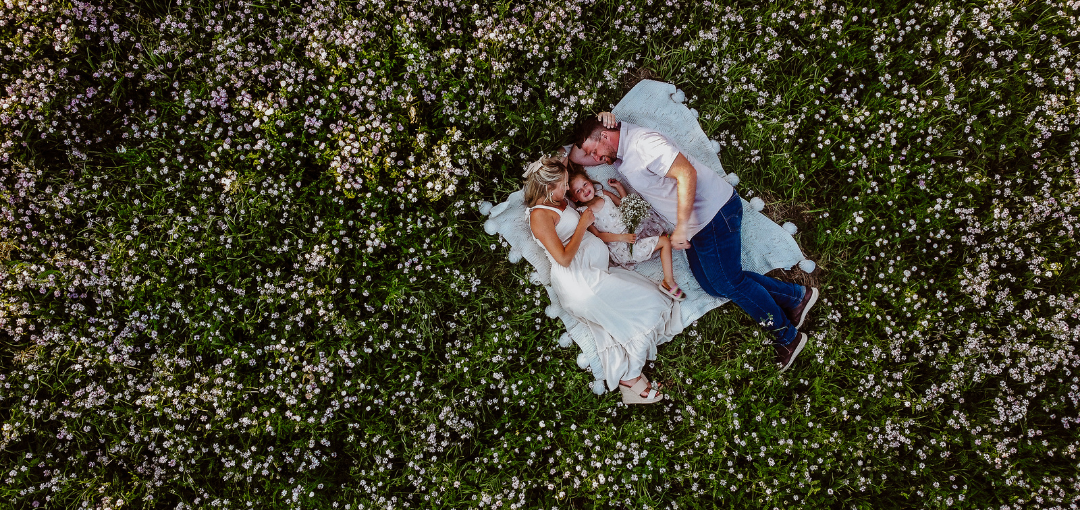 Family Lying on Blanket in Grass